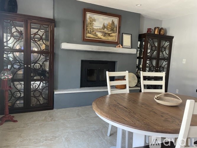 A dining room with a wooden table and chairs.