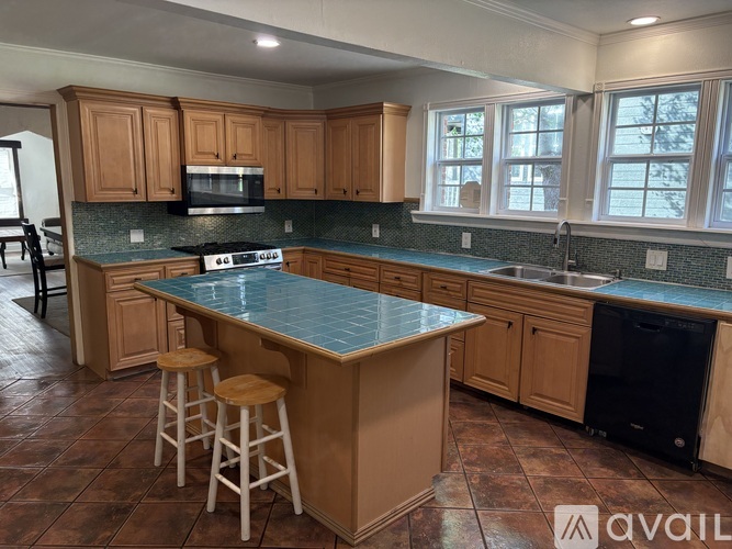 A kitchen with wooden cabinets and a blue countertop.