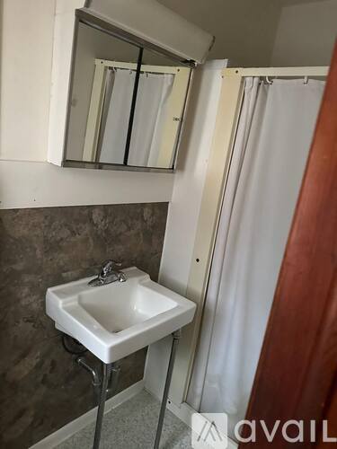 A bathroom with a sink and a mirror.