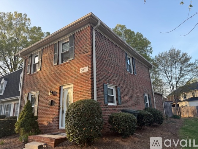 A brick house with a white door and windows.