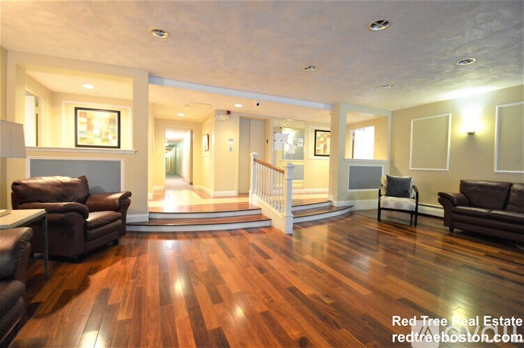 A living room with wood floors and furniture.