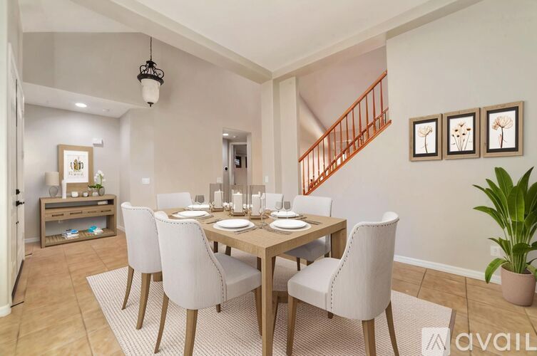 A dining room with a wooden table and chairs.