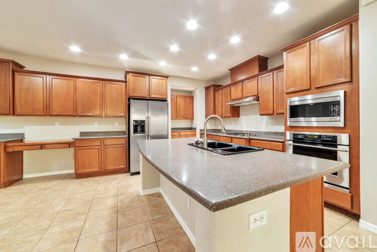 A kitchen with wooden cabinets and a granite countertop.