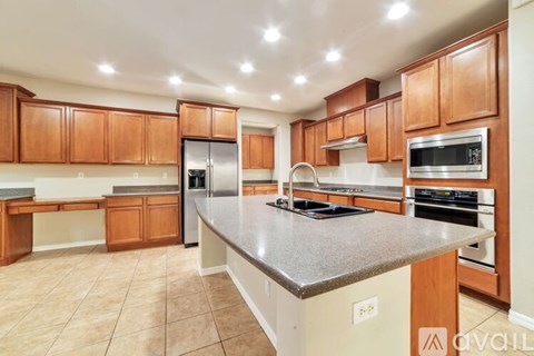 A kitchen with wooden cabinets and a granite countertop.