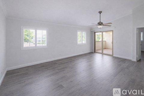 A kitchen with white cabinets and stainless steel appliances.