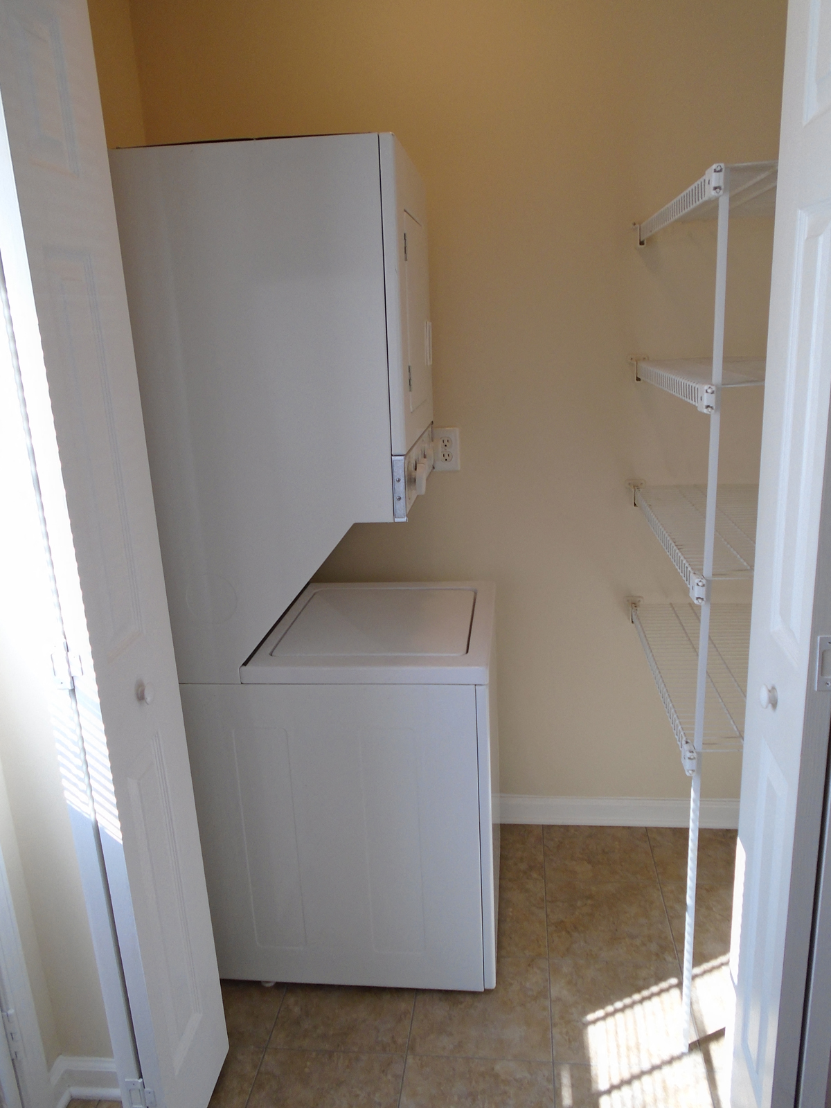 an empty laundry room with a washer and dryer