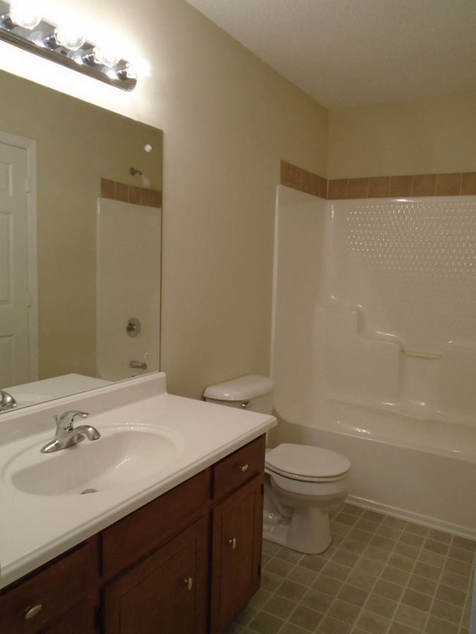 a small bathroom with a sink toilet and shower