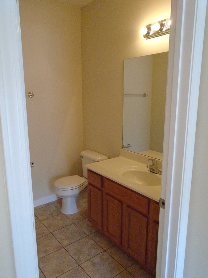 a bathroom with a sink toilet and a mirror