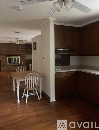 A kitchen with a table and chairs in it.