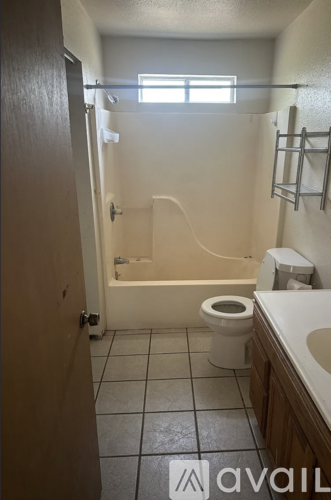 A bathroom with a toilet, sink, and bathtub.