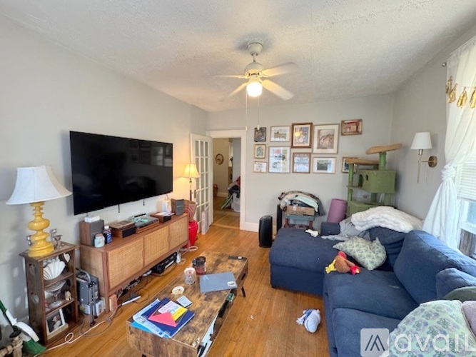 A living room with a television, a couch, and a coffee table.