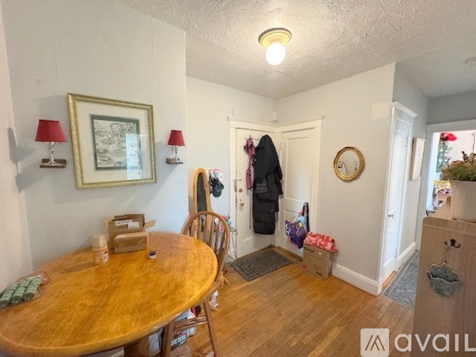 A room with a wooden floor and a white door.