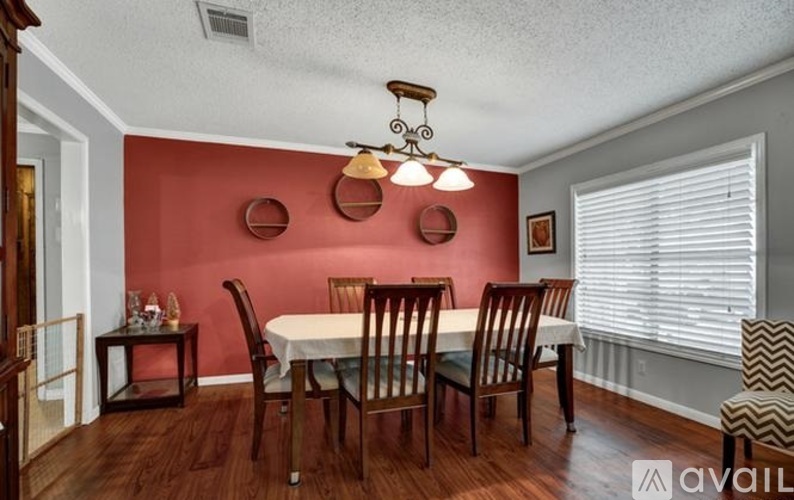 A dining room with a white table and chairs.