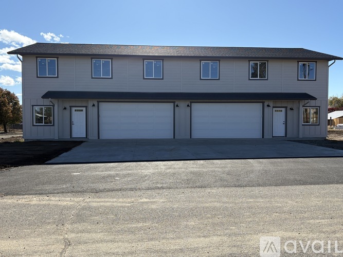 A two-story house with a garage is available for rent.