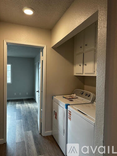 A small laundry room with a washer and dryer.