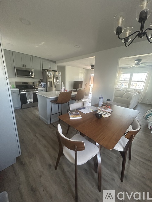 A modern kitchen with a dining table and chairs.