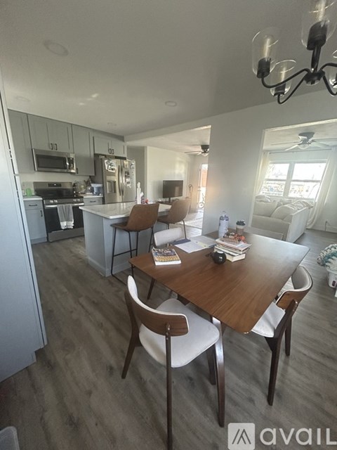 A modern kitchen with a dining table and chairs.