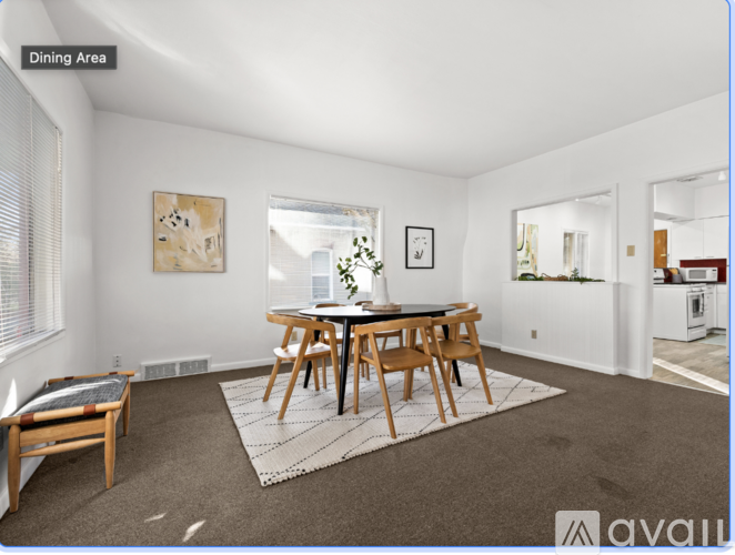 A dining area with a table and chairs.