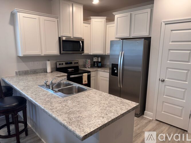 A kitchen with granite countertops and stainless steel appliances.
