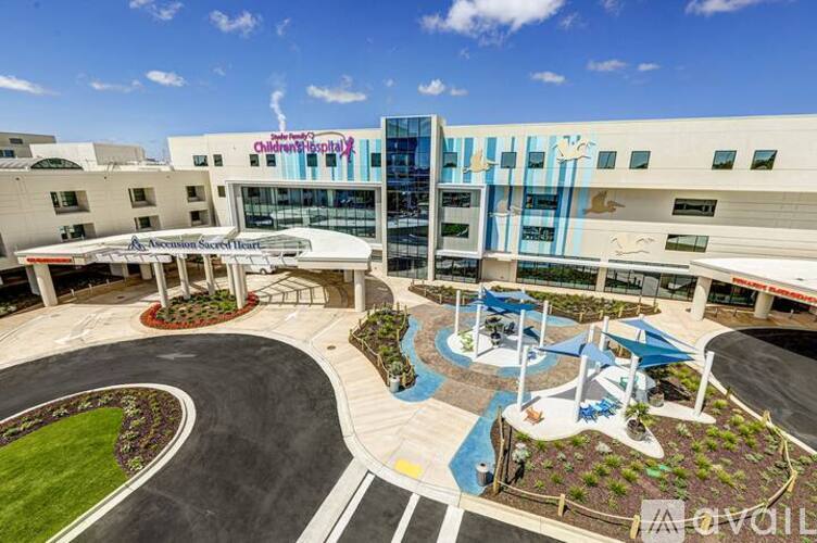 A hospital courtyard with a playground and a building in the background.