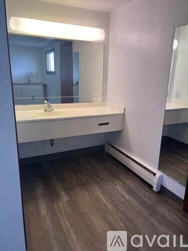A bathroom with a large mirror and a sink.