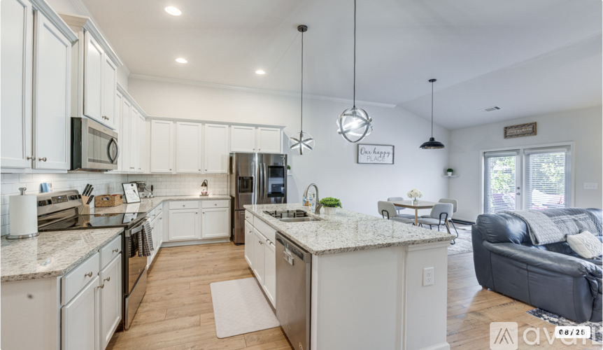 A modern kitchen with white cabinets and a large island.