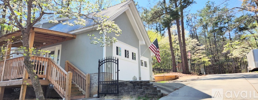 A house with a flag on the front porch is for sale.