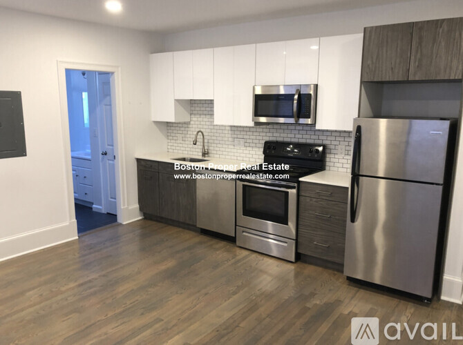 A kitchen with a stainless steel refrigerator, oven, and microwave.
