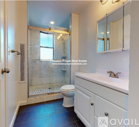 A bathroom with a toilet, sink, and shower.
