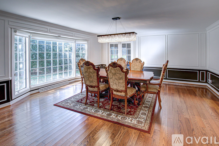 A dining room with a table set for six.