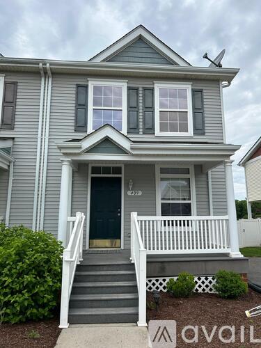 A house with a grey exterior and a white porch.