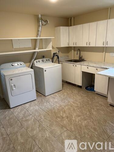 A kitchen with a washer and dryer.