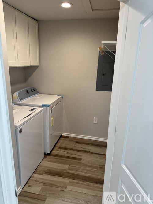 A small kitchen with a washer and dryer.