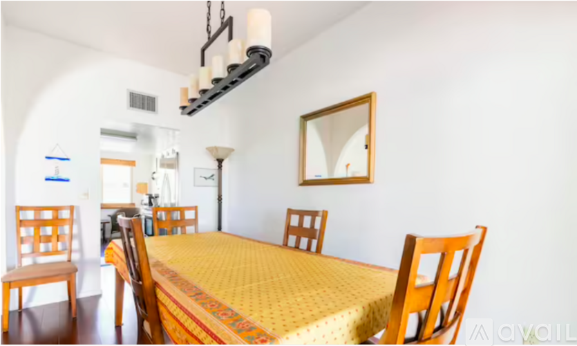 A dining room with a table and chairs.