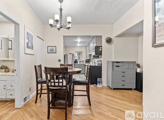 A dining room with a wooden table and chairs.