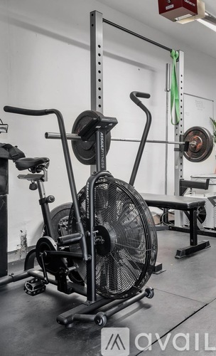 A gym with a rowing machine in the foreground.