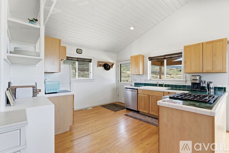 A kitchen with wooden cabinets and a white refrigerator.
