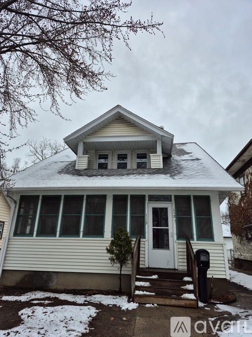 A house with a white door and a small porch.