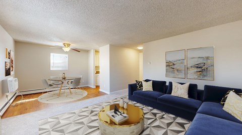 A living room with a blue couch and a coffee table.