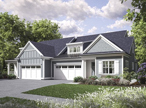 A house with a grey roof and white garage doors.