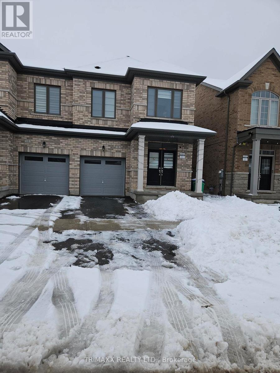A house with a snow-covered driveway in front.