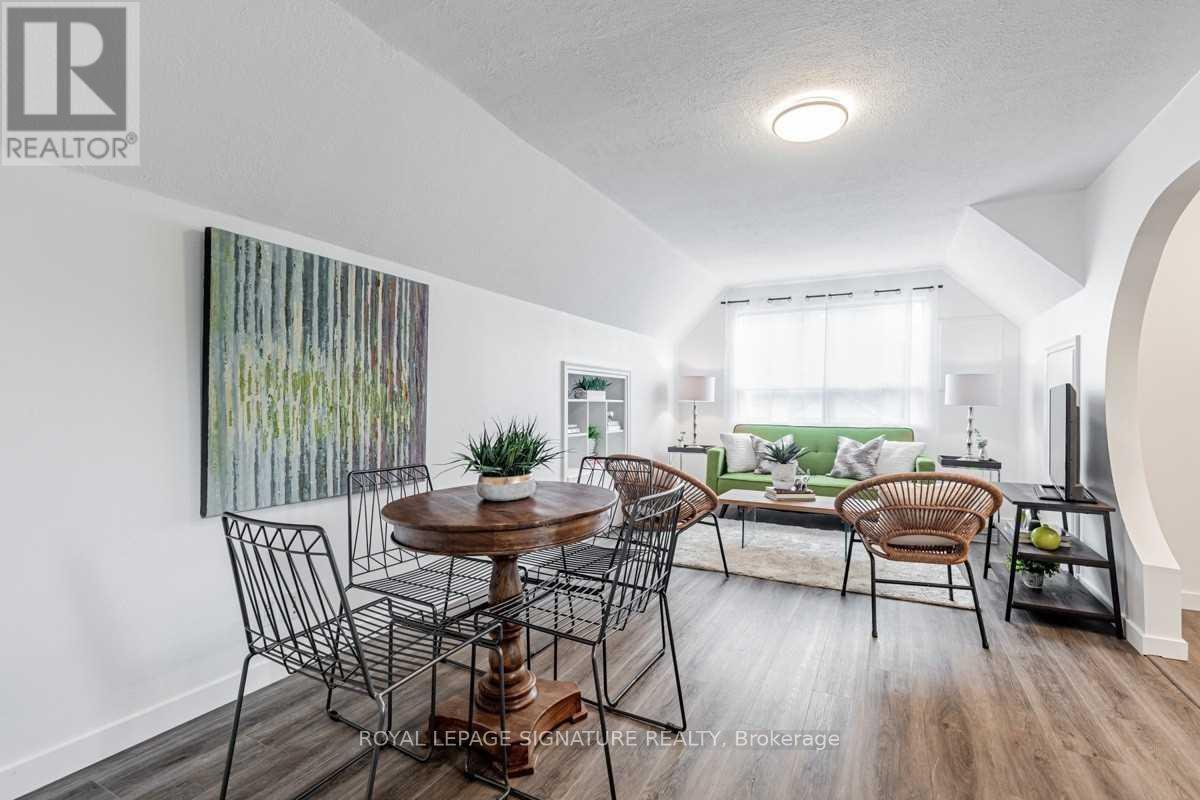 A dining room with a wooden table and chairs.