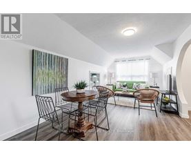 A dining room with a wooden table and chairs.