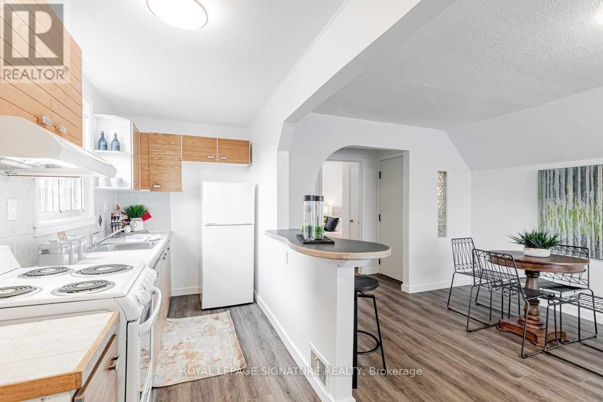 A kitchen with white appliances and a bar area.