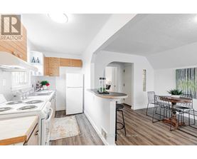 A kitchen with white appliances and a bar area.