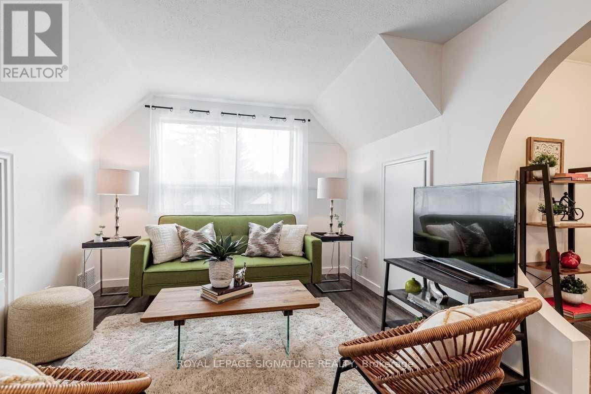 A living room with a green couch and a television.