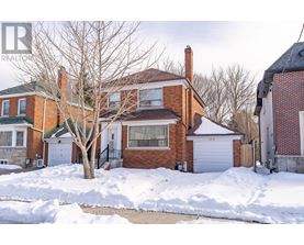 A house with a snow-covered front yard.