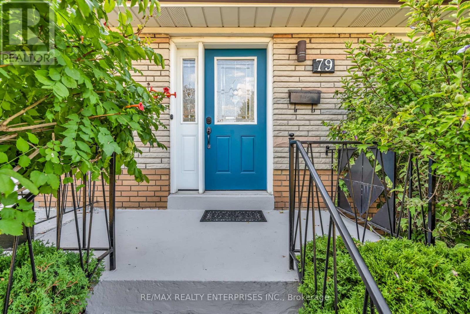 A blue door is the centerpiece of this house entrance.