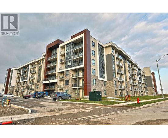 A large apartment building with a parking lot in front.