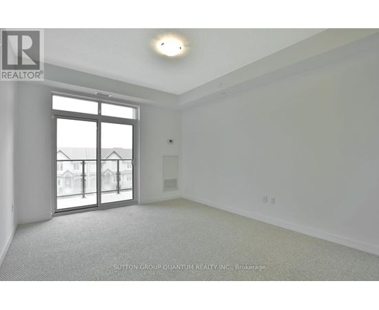 A room with a large window and a sliding glass door.
